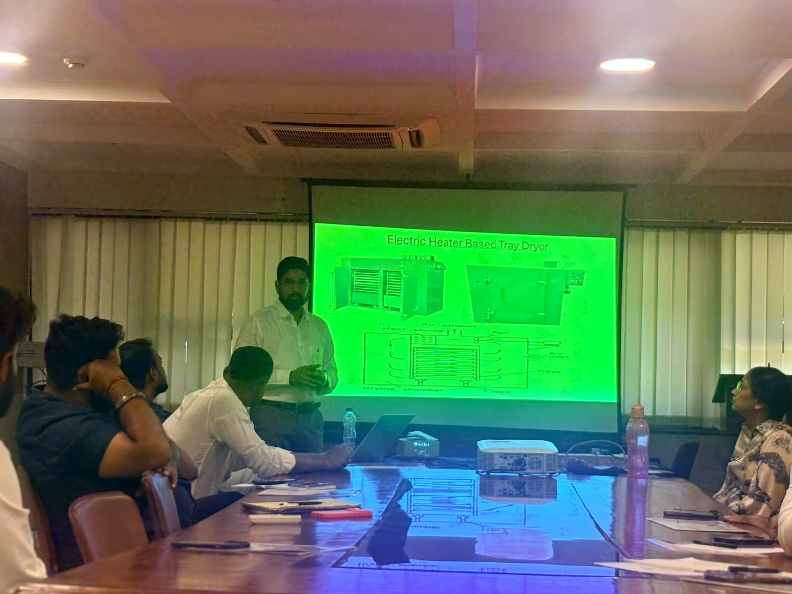Explaining tray dryer airflow and drying chamber during dehydration training in New Delhi